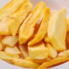 Close-up of thick-cut frozen potato fries.